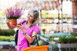 Young woman buying flowers at a garden center
