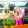 Young woman buying flowers at a garden center