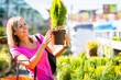 Young woman buying flowers at a garden center