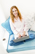 Woman with laptop computer looking up