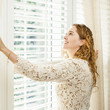 Smiling woman looking out window