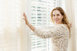 Smiling woman near window