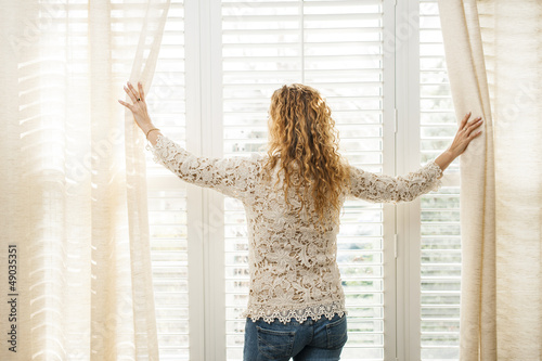 Photo: Woman looking out window Woman looking out window