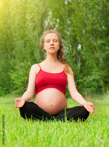 Photo: pregnant woman meditating in nature, practice yoga pregnant woman meditating in nature, practice yoga