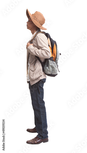 Photo: side view of backpacker standing on white side view of backpacker standing on white