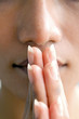 Closeup portrait of a young woman praying