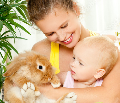 Photo: young mother,baby and their pet rabbit young mother,baby and their pet rabbit