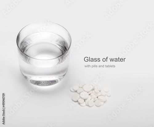 Photo: tablets and pills and glass of water tablets and pills and glass of water