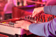 Dj mixes the track in the nightclub at a party
