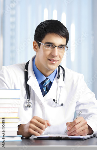 Photo: Writing doctor at office Writing doctor at office