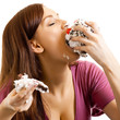 Cheerful woman eating pie, over white