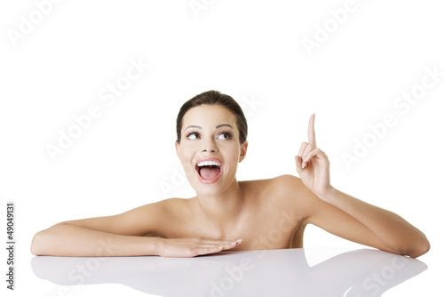 Photo: Attractive woman pointing on copy space. Attractive woman pointing on copy space.