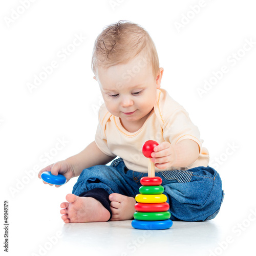 Photo: cute baby boy playing with colorful toy isolated on white backgr cute baby boy playing with colorful toy isolated on white backgr