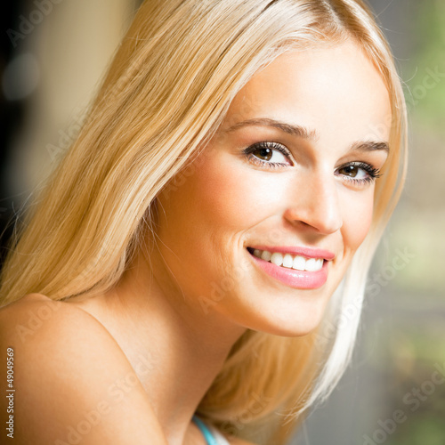 Photo: Smiling young beautiful woman, indoors Smiling young beautiful woman, indoors