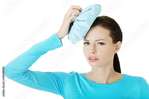 Photo: Young woman suffering from migraine Young woman suffering from migraine