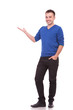 happy young casual man presenting something
