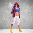 sporty woman standing with her hands in pockets