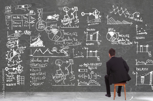 Photo: business man looking at some calculations business man looking at some calculations