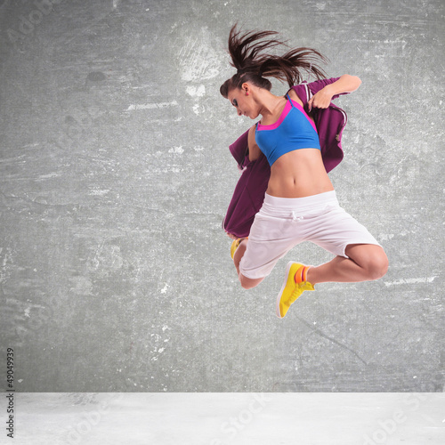 Photo: woman dancer screaming and making a difficult jump woman dancer screaming and making a difficult jump