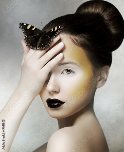 Photo: Romantic Woman holding Butterfly in her Hand. Fantasy Romantic Woman holding Butterfly in her Hand. Fantasy