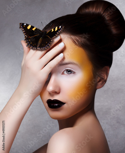 Photo: Trendy Woman with Butterfly. Creative Bright Make Up. Black Lips Trendy Woman with Butterfly. Creative Bright Make Up. Black Lips