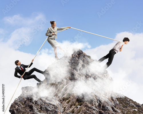 Photo: Three business people pulling rope Three business people pulling rope