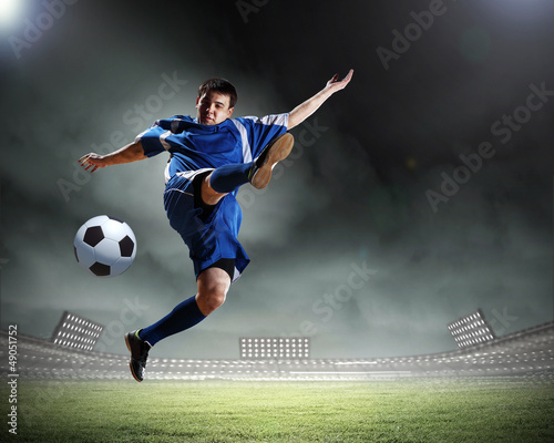 Photo: football player striking the ball football player striking the ball