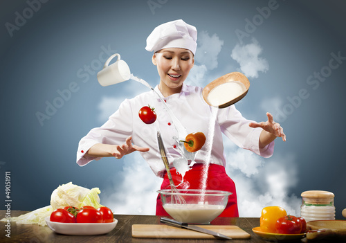 Photo: Asian female cooking with magic Asian female cooking with magic