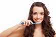 Young woman at home brushing teeth