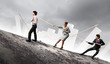 Three business people pulling rope