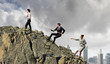 Three business people pulling rope