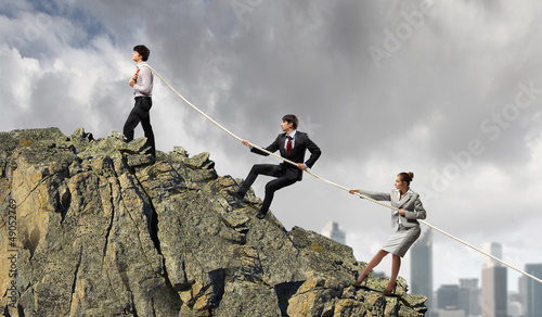 Photo: Three business people pulling rope Three business people pulling rope