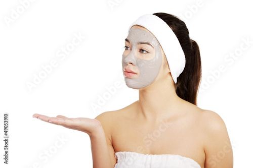 Photo: Beautiful woman with clay facial mask Beautiful woman with clay facial mask
