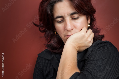 Photo: Portrait of a thoughtful and worried hispanic woman Portrait of a thoughtful and worried hispanic woman