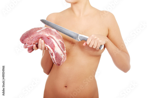 Photo: Nude woman holding big part of raw meat (pork neck). Nude woman holding big part of raw meat (pork neck).