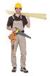 craftsman holding wooden boards and a saw