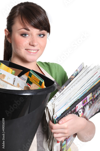 Photo: Young woman recycling paper Young woman recycling paper