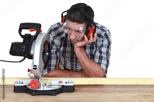 Photo: Carpenter using miter saw Carpenter using miter saw