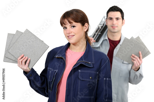 Photo: Couple with tile cutter Couple with tile cutter