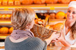 Salesperson with female customer in bakery