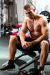 Man in gym or fitness studio on weight bench