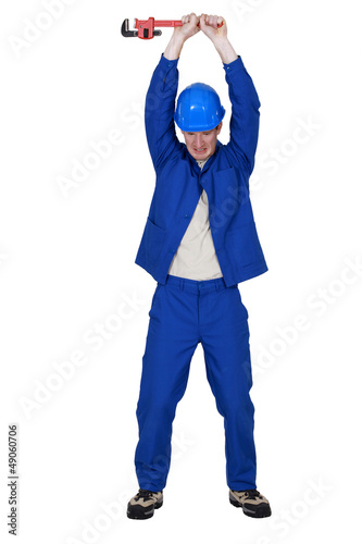 Photo: Workers raising wrench Workers raising wrench