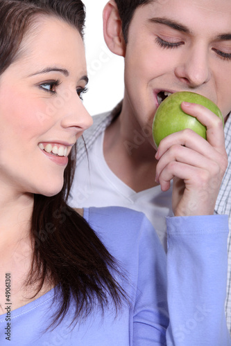 Photo: Couple eating an apple Couple eating an apple