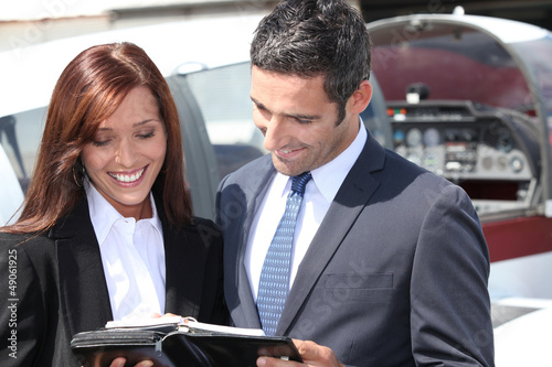 Photo: Smiling businesspeople reading notes Smiling businesspeople reading notes