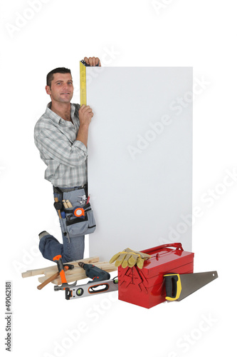 Photo: craftsman taking measurements craftsman taking measurements