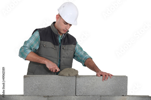 Photo: Bricklayer laying blocks Bricklayer laying blocks