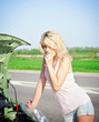 Foto: Blonde girl stands near the broken car Blonde girl stands near the broken car