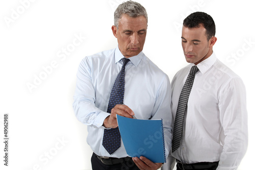 Photo: Businessmen discussing a document Businessmen discussing a document