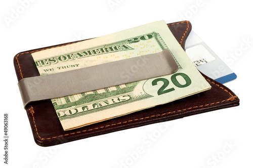 Photo: Dollars in money clip and credit card. Dollars in money clip and credit card.
