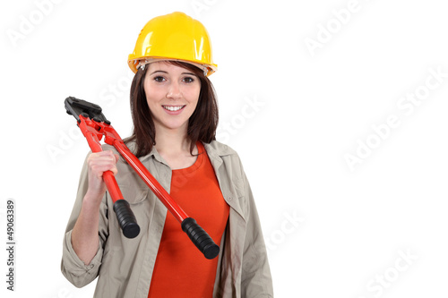 Photo: Young tradeswoman holding large clippers Young tradeswoman holding large clippers